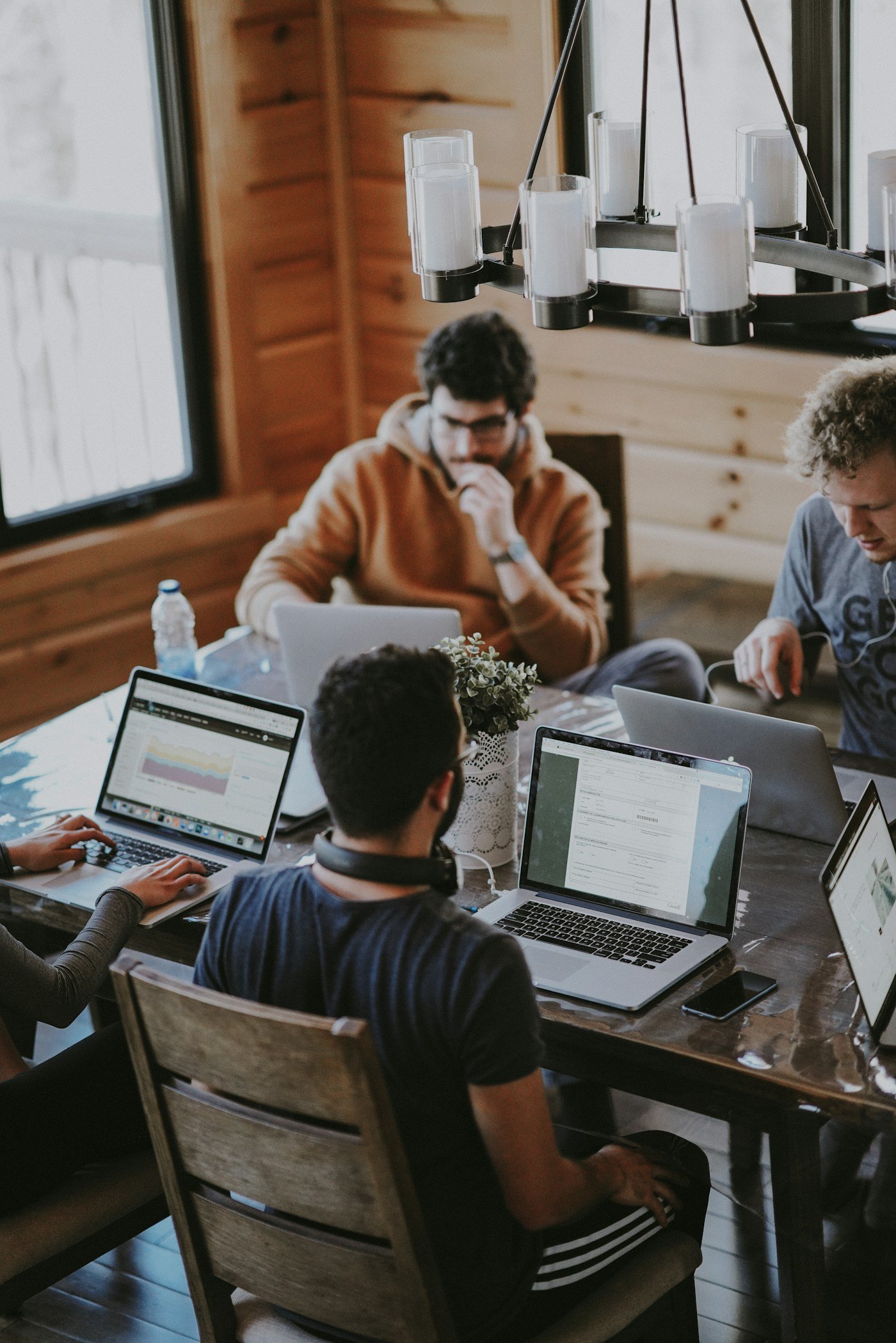 A team collaborating around a laptop