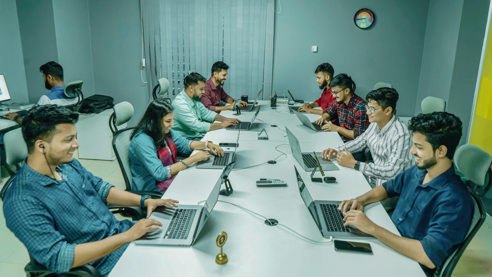 Team collaborating on a business application workflow with laptops