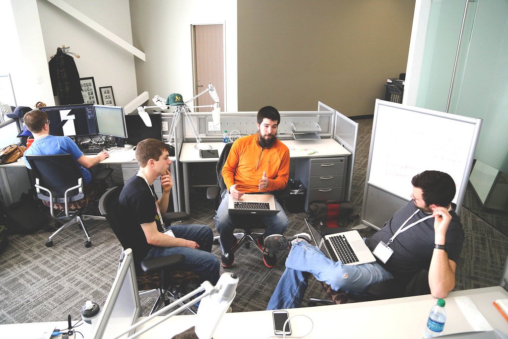 Team collaborating around Gemini Enterprise knowledge and a whiteboard