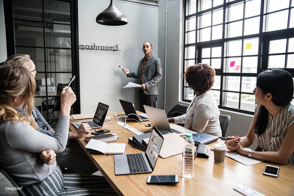 Business team using Gemini Enterprise AI with laptops and connected business information