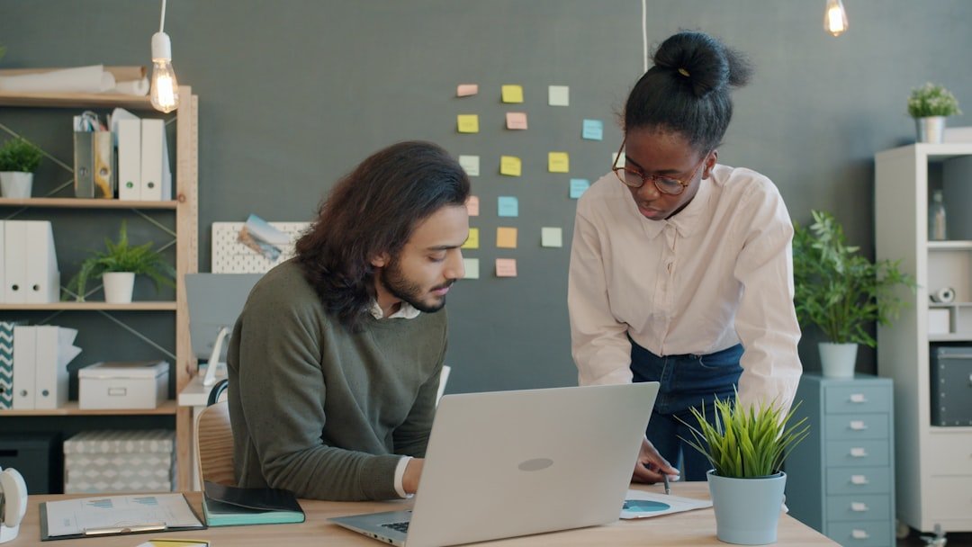 Colleagues using AI tools while reviewing work in a modern office