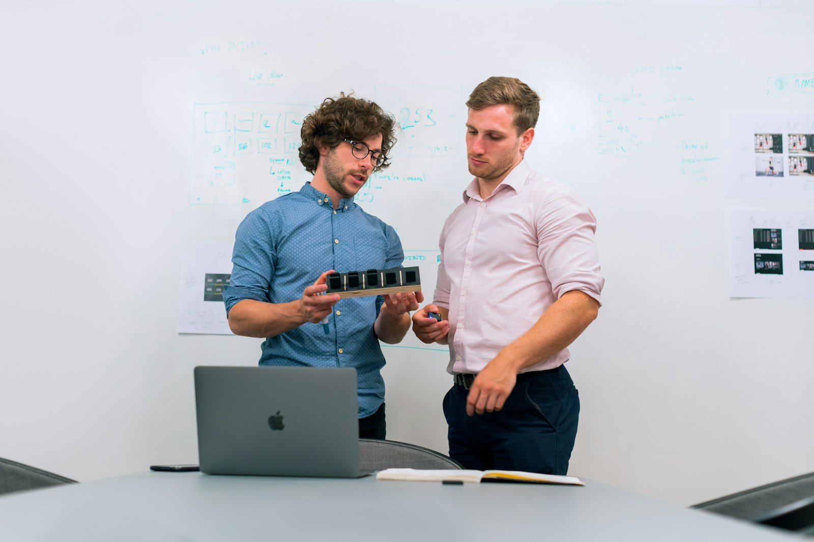 Engineers reviewing a technical infrastructure design on a laptop