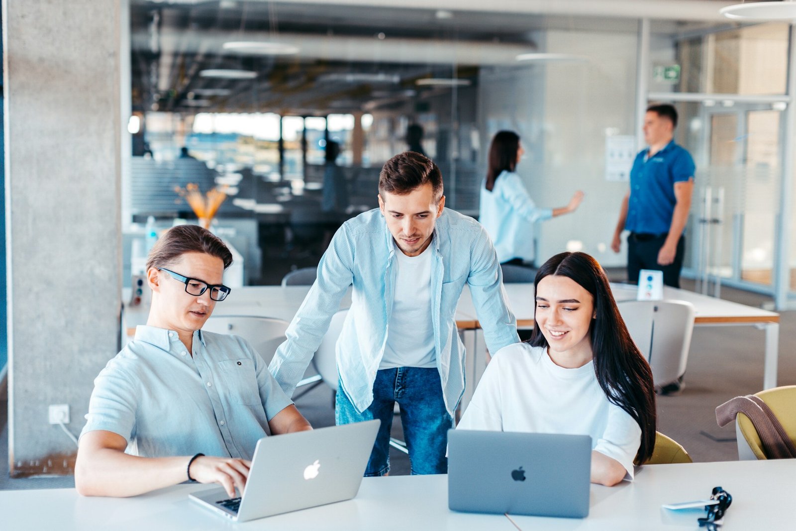 Business team collaborating around a laptop in a modern office